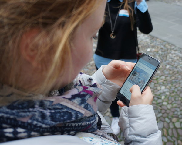 A woman playing the Bergamo Quest app