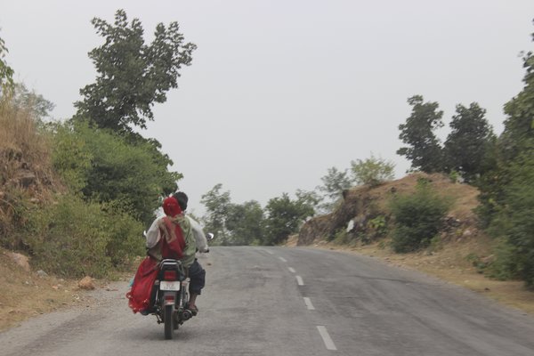 An indian man and his wife on a bike on the kumbhalgarh fort road, india. (Photo Credit: MBS Photography)